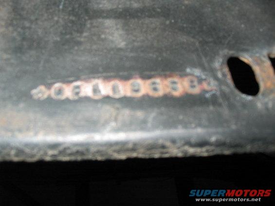Stamped numbers 06000688 on a dark metal surface
