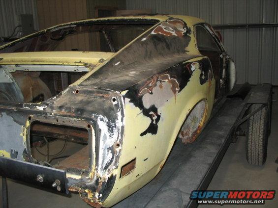 1970 Ford Mustang rear quarter panel, yellow, rusty, on trailer
