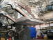 1986 Toyota Hilux - Underside view of a custom-fabricated transfer case skid plate and associated drivetrain components.