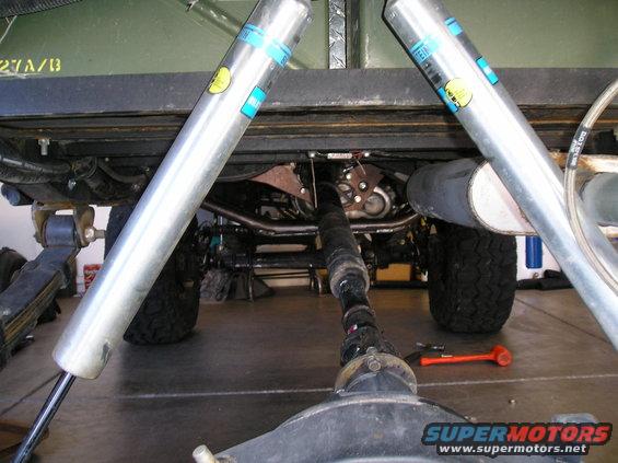 Underneath a lifted 4x4, showing Bilstein shocks, driveshaft, and differential