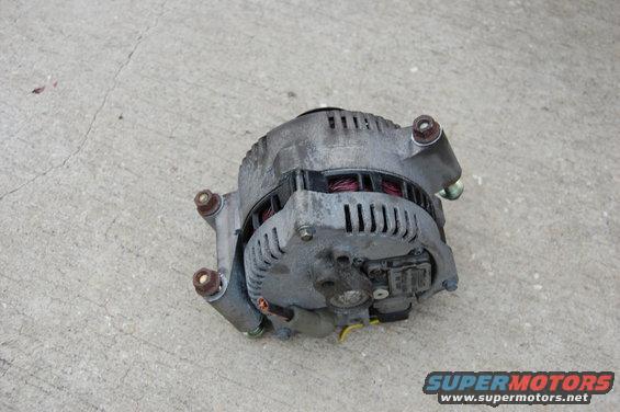 car alternator sitting on concrete surface