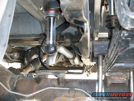 Undercarriage view of a vehicle's suspension with a shock absorber and leaf springs