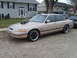 1993 Ford Crown Victoria - A modified sedan with a prominent hood scoop sits parked in front of a suburban house.