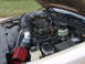 1993 Ford Crown Victoria - Engine bay of a vehicle an aftermarket air intake system and custom piping.
