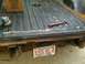 1993 Ford Bronco - Tools are laid out in a rusty truck bed, ready for repair work.