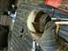 1993 Ford Bronco - Close-up of a damaged exhaust pipe section being held, with tools in the background.