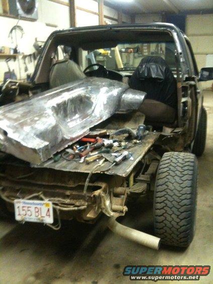 1993 Ford Bronco body with rear disassembled, showing fuel tank removed and tools on the bed. Massachusetts license plate 155 BL4 visible