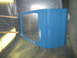 1977 Ford F-150 - A blue truck door is being prepped for painting in a spray booth.