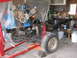 1977 Ford F-150 - Vehicle chassis and engine undergoing work in a garage setting.