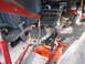 1977 Ford F-150 - The frame of a vehicle is being worked on, supported by an engine hoist and jack stands.