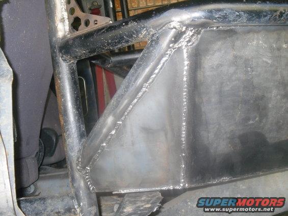 Close-up of a custom-welded metal cage structure inside a vehicle, likely for off-roading