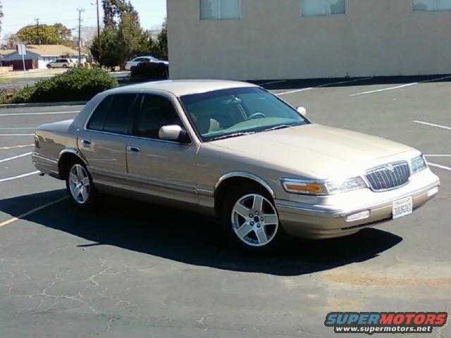 Gold 1997 Mercury Grand Marquis parked in a lot