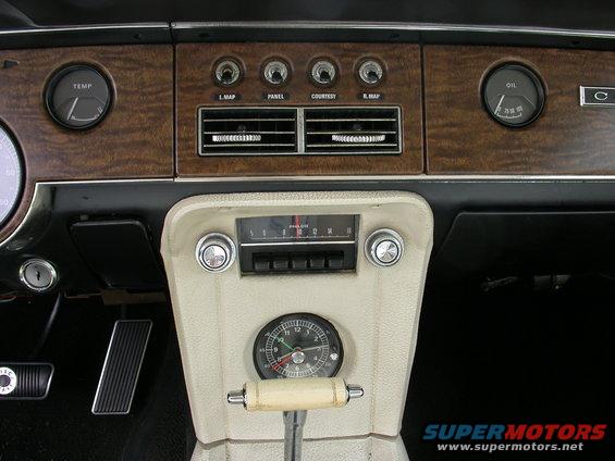 1968 Mercury Cougar interior dashboard with wood grain trim, clock, and gauges