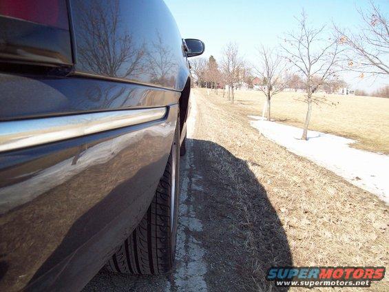 1999 Mercury Grand Marquis side view, showing rear quarter panel and tire