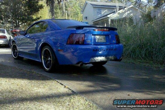 Blue Ford Mustang rear view with spoiler and custom exhaust