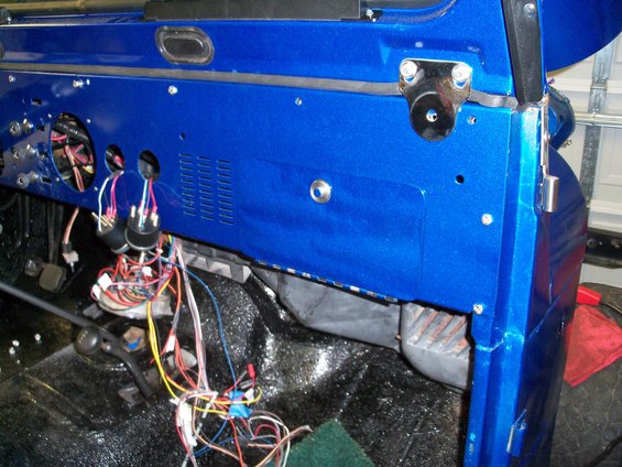 blue dashboard with exposed wiring and gauges