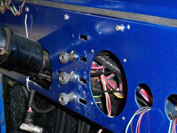 Blue dashboard panel with exposed wiring and four toggle switches