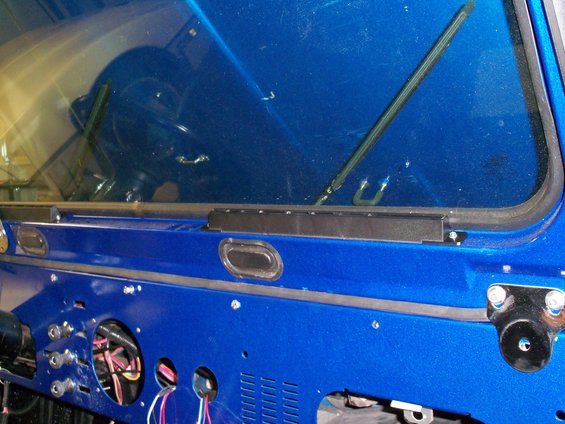 Blue dashboard and windshield interior of a vehicle