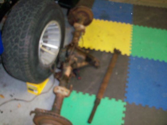 Front axle assembly and shock absorber on interlocking floor mats