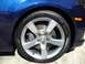2010 Chevrolet Camaro - Close-up of the front wheel and fender of a blue 2010 Chevrolet Camaro, a Brembo brake caliper and Pirelli tire.