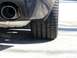 2010 Chevrolet Camaro - Close-up view of a vehicle's rear tire and exhaust pipe.