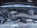 1994 Ford Bronco - View of the engine bay, showing various mechanical parts and wiring.