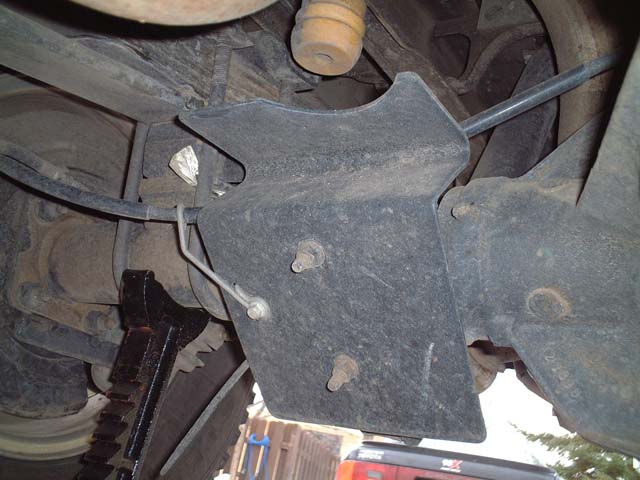 dscf0005.jpg Make a note for where your parking break cable runs around this shock/heate plate.  I had to refer back to my digital photos when I was reassembling because I wasn't sure which side of the plate the cable mounted on.  If you mount it incorrectly, the cable will wear against the plate.