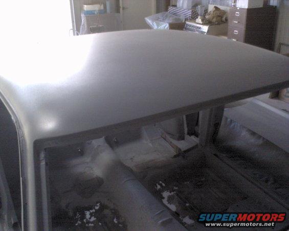 Roof looks really good.  That is not a dent.  That's the light in the ceiling.  Minor body work required around the Louver hinge area.  That's it.