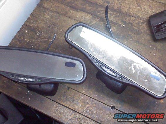 Two auto-dimming rearview mirrors with buttons labeled COMP and MIRROR on a wooden surface
