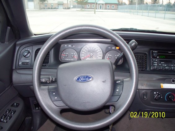 2005 Ford Crown Victoria interior showing steering wheel, dashboard, and radio