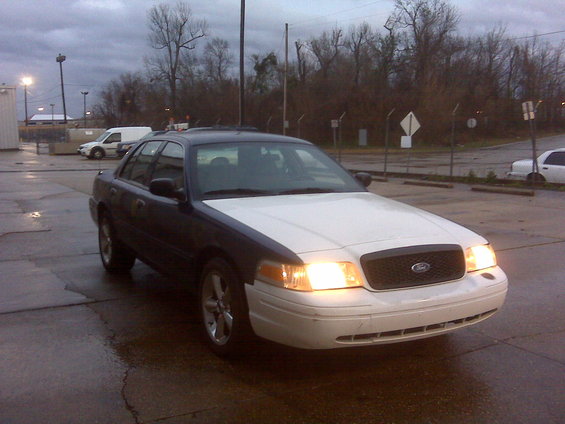 2005 Ford Crown Victoria, 3q front view, white hood and front bumper
