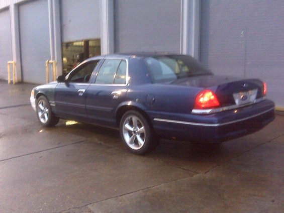 Dark blue 2005 Ford Crown Victoria parked outside a garage