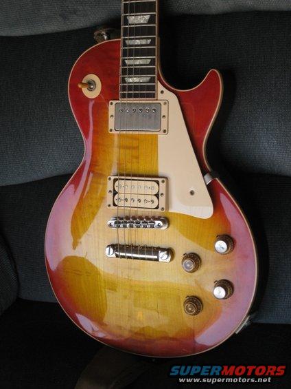Sunburst finish electric guitar with cream pickguard and chrome hardware