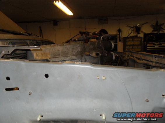 close-up of vehicle frame with engine parts visible above