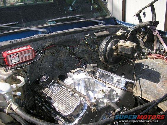 Engine bay showing a V8 engine with chrome valve covers, MSD ignition box, and brake booster