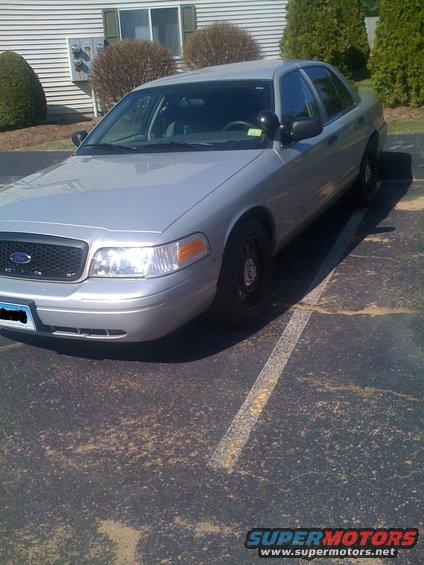 Silver 2009 Ford Crown Victoria parked in a lot, front quarter view