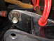 1996 Ford Bronco - Close-up of a metal automotive part, possibly a suspension component, secured with a clamp.