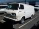 1966 Ford E100 - A white Ford Econoline van is parked in a lot, showing its front and side profile.