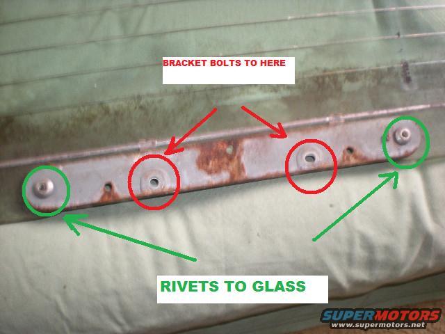 metal bracket with red arrows pointing to bolt holes and green arrows pointing to rivets, text says 'BRACKET BOLTS TO HERE' and 'RIVETS TO GLASS'