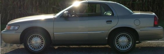 Gold 2000 Mercury Grand Marquis sedan, side view