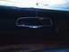 1977 Ford F-100 - The interior of a vehicle is visible, focusing on the rear-view mirror and dashboard area.