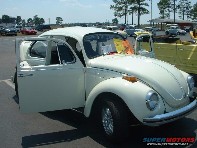 White 1972 Volkswagen Beetle with doors open, parked outdoors