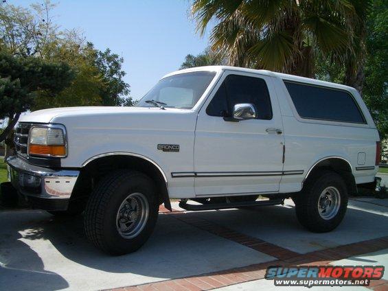 1992 Ford Bronco parked on a paved driveway, side view