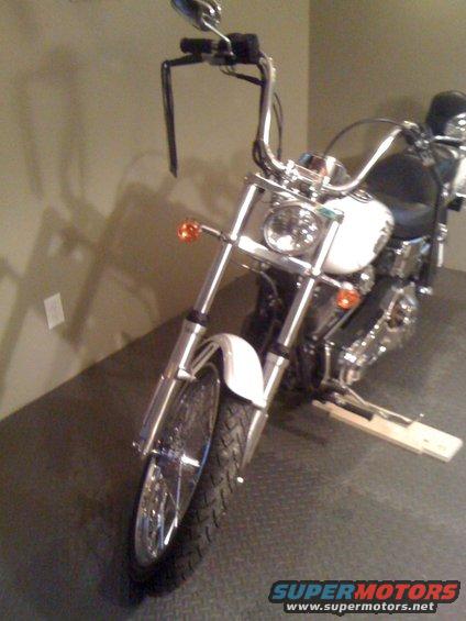 Motorcycle front view with chrome handlebars and white fender