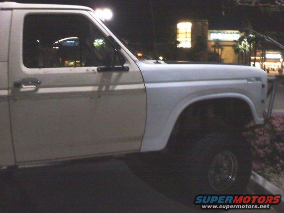 White Ford Bronco, side view, showing door and fender