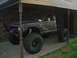 1984 Ford Bronco II - This heavily modified SUV, likely from the early 1980s, features oversized tires and a custom roll cage.