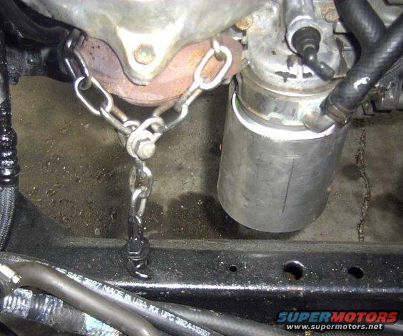 Engine part held by chain