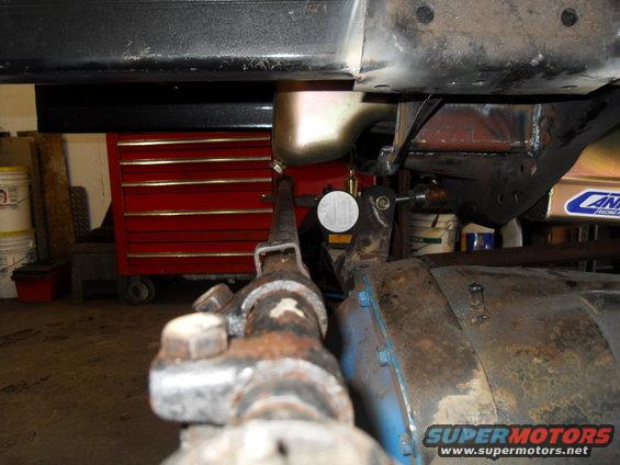 Close-up of vehicle undercarriage with a red toolbox visible