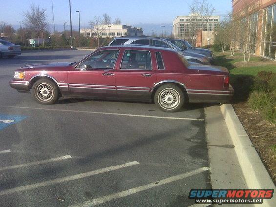 Maroon 1993 Lincoln Town Car side view