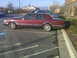 1993 Lincoln Town Car - This maroon 1993 Lincoln Town Car is parked in a lot, showing its side profile.